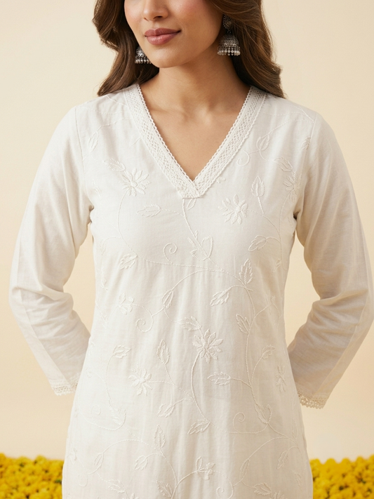 White cotton embroidered kurta pant set with matching dupatta and delicate floral embroidery, elegant women's ethnic wear for festive and everyday occasions.