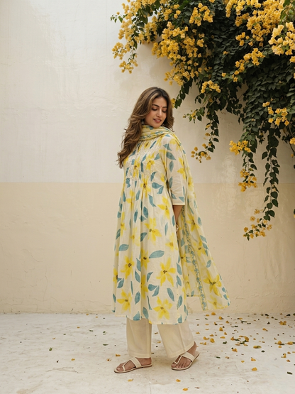 Floral cotton suit set featuring pintuck embroidered yoke and lightweight Kota Doriya dupatta